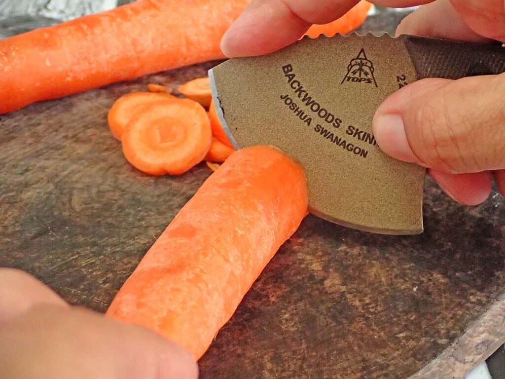 In ulu mode with the Backwoods Skinner, the author sliced raw carrots effortlessly. The edge geometry works for food and game prepping. 