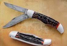 Josh Howard’s Folding Hunter features a remarkable 3.5-inch hollow-ground blade crafted from pattern-welded damascus depicting a detailed deer hunting scene. Measuring 9 1/8 inches overall, the knife is built on a stainless steel frame with stainless bolsters and classic amber stag handle scales. (SharpByCoop image)