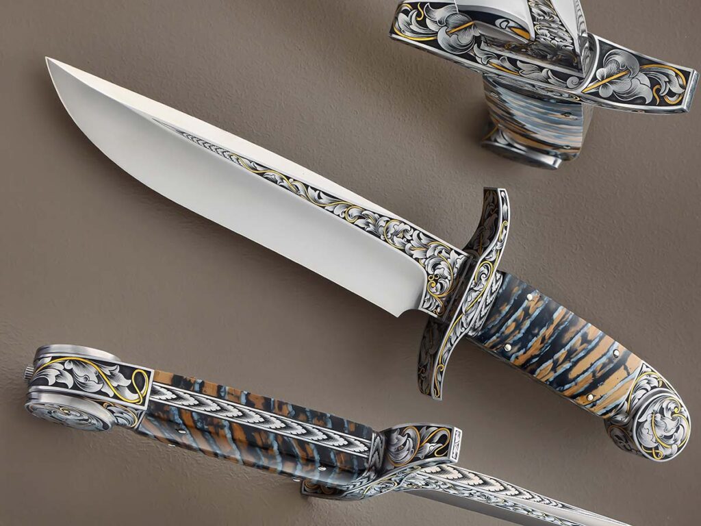 Dennis Friedly opts for CPM 154 stainless blade steel and a mammoth tooth handle for his Art Knife Invitational fighter. The copious engraving is by Ray Cover Jr. Overall length: 13 inches. (SharpByCoop image)