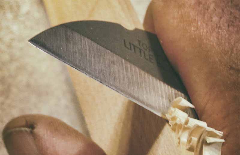 A small straight-edge knife makes a great tool for controlled cuts. The author uses the TOPS Knives Little Bugger to make wood curls with a paring-style cut.