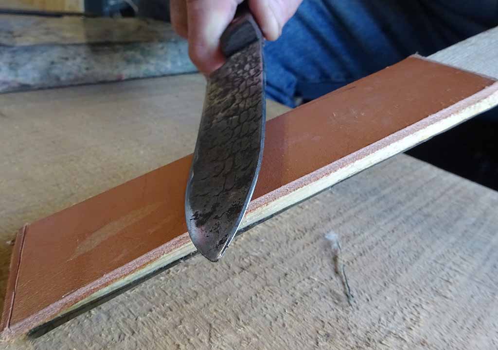 The same exact motion is used on the leather side of the strop stick. When the smith is “into” the motion it is similar to a continuous figure-8 movement. Most of the time the leather is enough to restore the blade’s edge without using the sandpaper side of the stick.
