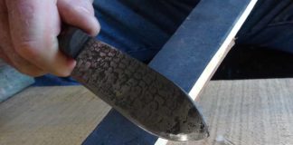 This is the strop on the 1500 grit sandpaper side of the strop stick. The angle is maintained while the smith slides the edge back and forth several times to break the burr. The smith travels the length of the stick and the length of the blade’s edge in a continuous motion.