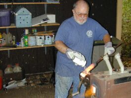 In his final years of knifemaking, Tim—inset applying flux to twisted steel in his forge.