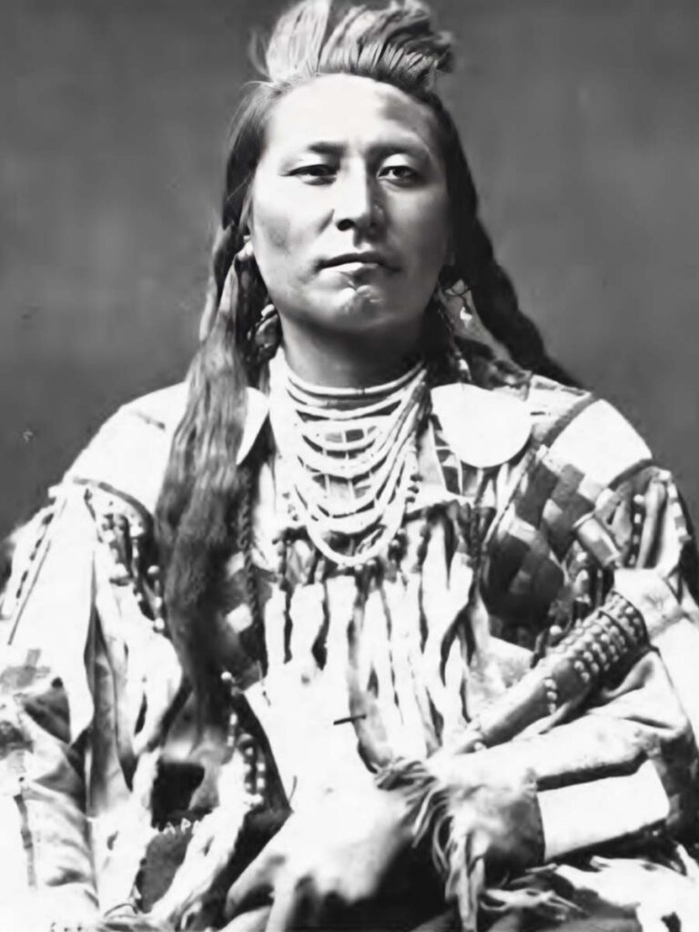 Crow Chief Plenty Coups holds a fine tack-decorated pipe tomahawk circa 1880 during a visit to Washington, D.C. (Smithsonian Institution, Bureau of American Ethnology, Washington, D.C. image)