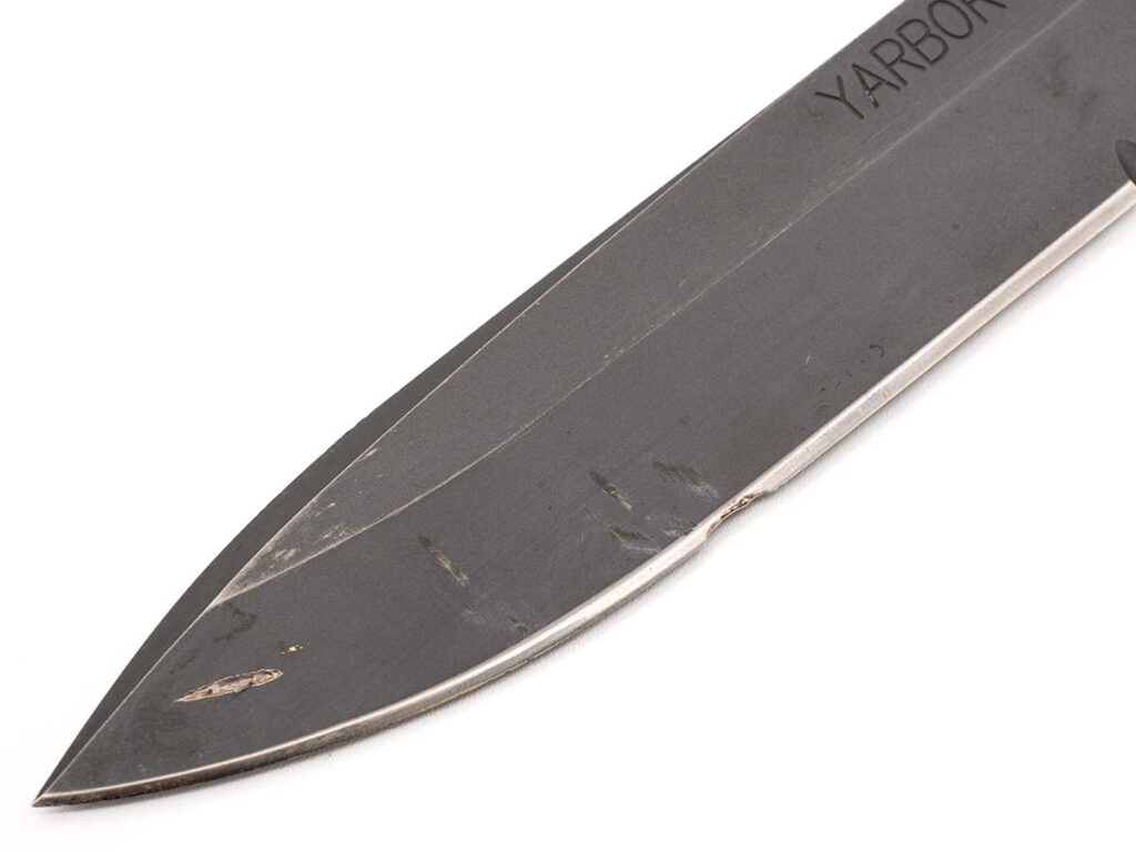 A closeup of the blade and edge damage the Chris Reeve Knives Yarborough incurred after being used by the SF operative to cut a live electric cable is a tribute to the toughness of the company’s knives.
