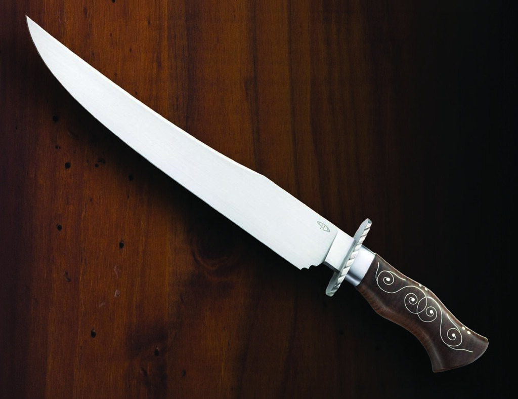 ABS journeyman smith Patrick Harp of Nevada won the William Moran Award for the best knife in the Moran style. In addition to a striking polished blade, the knife features fine wire inlay in a toasted curly maple handle. (Mitchell Cohen image)