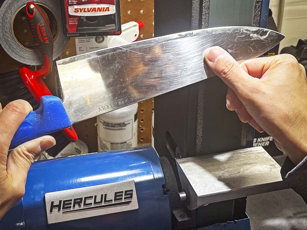 Image 3: Now that the dings have been removed, we need to create a starter edge. Best way to do this is to approximate a 20-degree angle and carefully grind away.