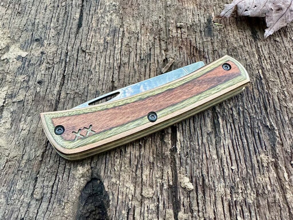 The Classic American Case Sodbuster Jr. is a testament to U.S. craftsmanship and durability. It embodies reliability, functionality, and traditional style all in a compact design. The Sod Buster Jr. in this photo has a 2.875-inch stonewashed skinner blade and a Smooth Black Canvas Laminate handle with Day Glow G10 liners.