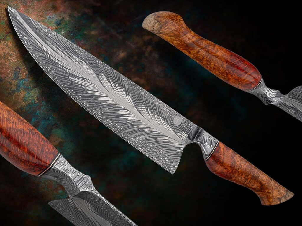 Winning Best Damascus at the 2025 BLADE Show West, Trevor Morgan’s “Torrent of Fire” chef’s knife includes a 9.25-inch blade of 1084 and 15N20 in a mix of W’s and straight layers with a fat core of 15N20. The knife’s overall length is 14.2 inches, and the handle is dark red tiger’s blood amboyna burl with a splash of sapwood for contrast. (Jocelyn Frasier image)