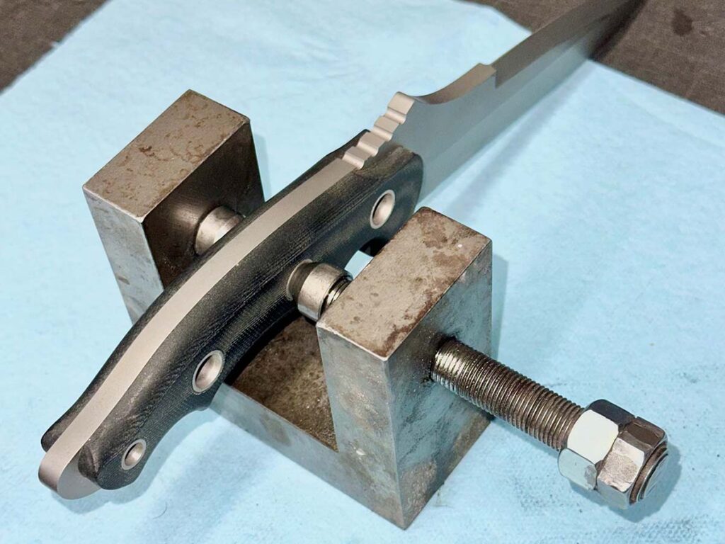Sibert came up with a custom jig (left) to compress and flare 3/8-inch Grade 2 seamless titanium tubing on mortised scales. (Image courtesy Shane Sibert)