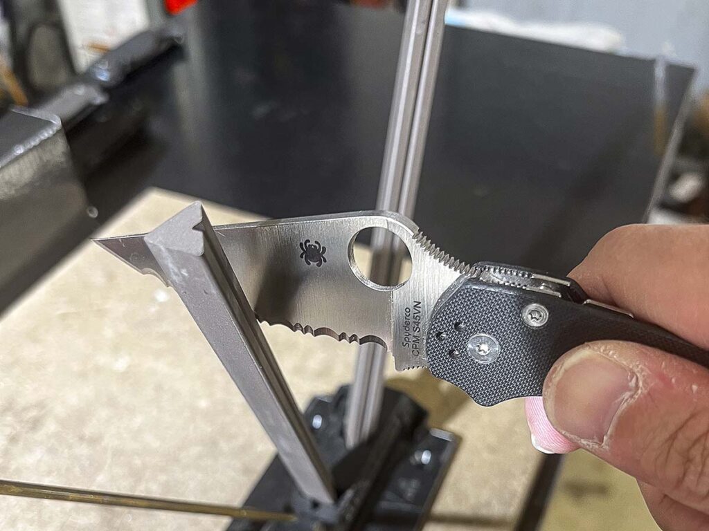 The Spyderco Sharpmaker 204 is the best sharpener to use with serrated knives, as it is easy to set up, easy to use and doesn't use oil or water for lubrication. The points of the triangular-shaped hones capture each tooth in the serration pattern effectively.