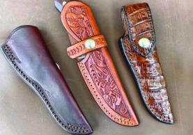 Three different styles of pouch sheaths by Kenny Rowe, from left: regular pouch, plain leather; strap pouch, floral hand carved; and full flap pouch, full coverage gator.