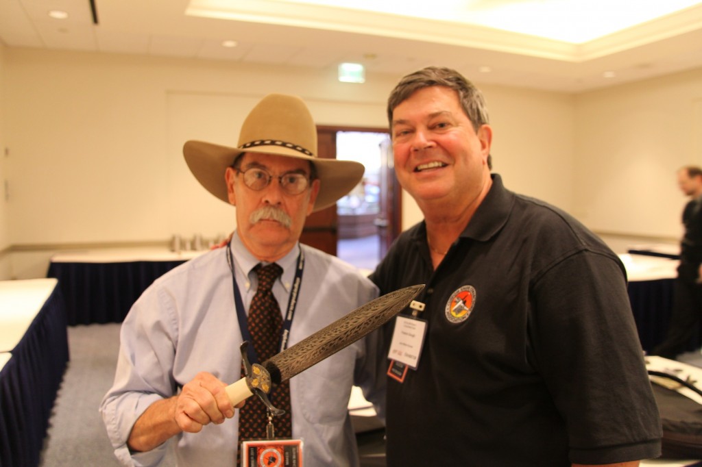 ABS master smith John White (left) holds his Best of Show and Best Damascus from the 2013 BLADE Show as the knife's owner, Preston Gough, enjoys the moment.