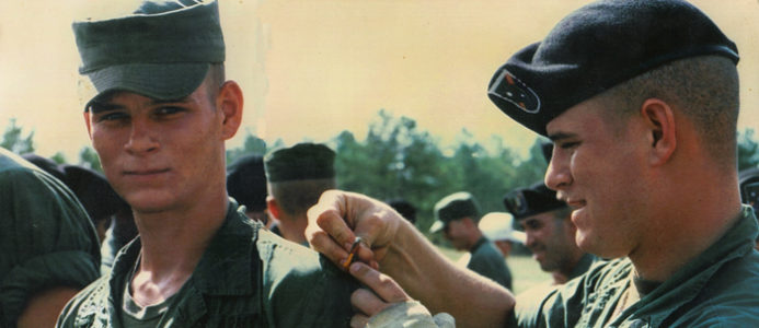 Then-Ranger Bob Horrigan pins the Ranger Tab on his twin brother John's shoullder at graduation from Ranger School.