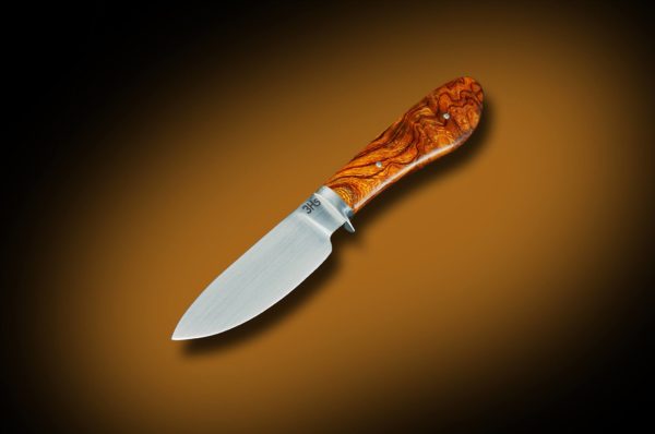 Raymond uses a Nessmuk-style drop-point design when making a skinner.
